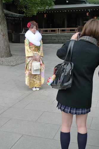Schoolgirl takes photo of kimono girl
