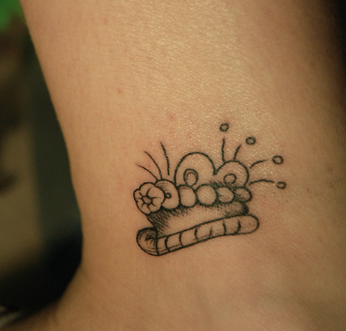 Ankle rosary tattoo.