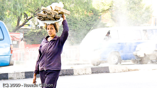 An Ethiopian woman carries a bundle of wood on her head in Addis Ababa.