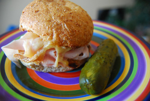 Ham with smoked cheddar on a bun with pickle