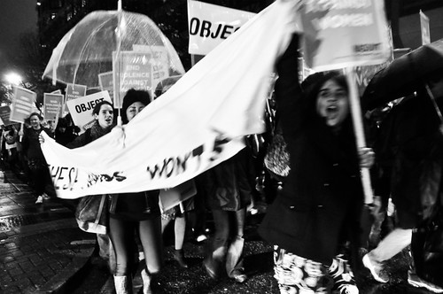 women dancing holding banner