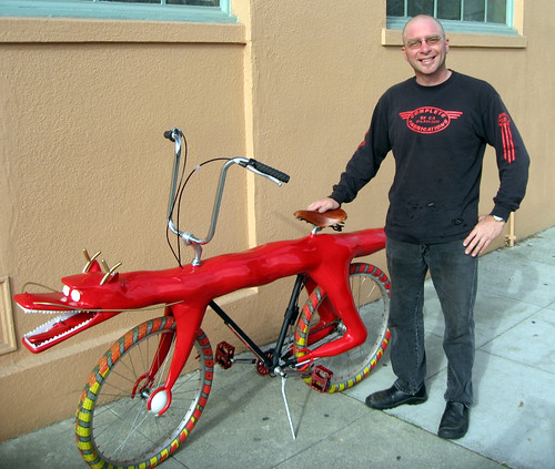 Jay Broemmel standing next to Dragon Bike