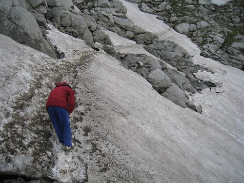Ashok digs out footholds on the steeply pitched snow