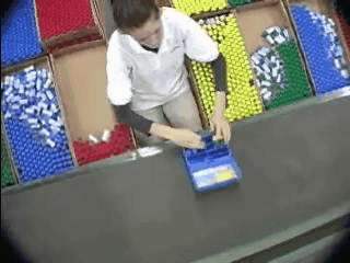 Bored Assembly Line Worker Loading Bottles into Plastic Container (With Animation)