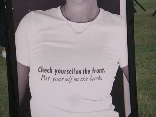 Self-exam reminder. Tee shirt reads "Check yourself on the front. Pat yourself on the back."