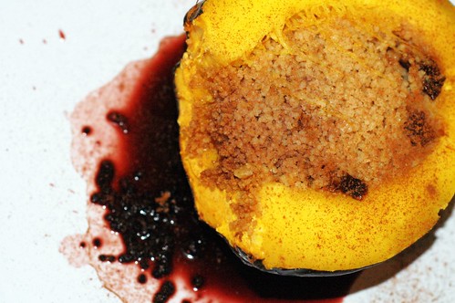 roasted acorn squash stuffed with spiced couscous in a wine reduction sauce