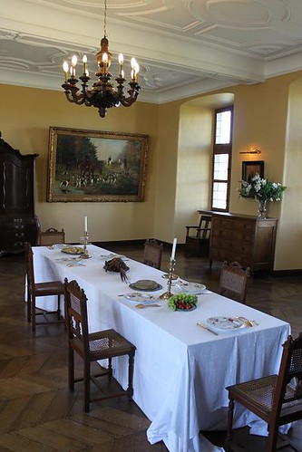 room in castle with big table and painting