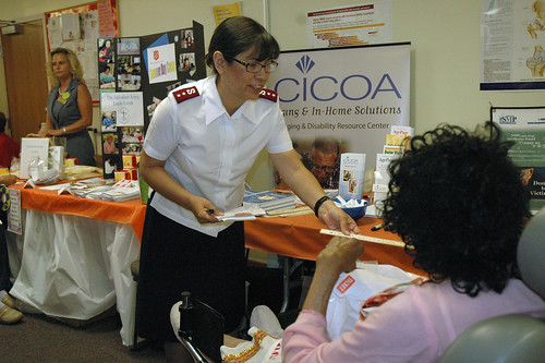 Captain Leti Crowell assist one of the seniors at the Health Fair hosted by The Salvation Army
