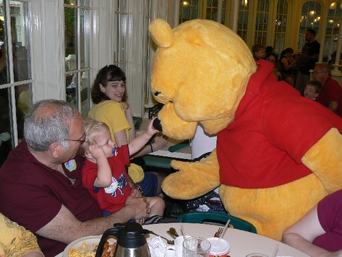 Papa helping JSL to be brave to honk Pooh Bear's nose