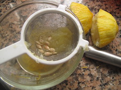 Squeeze lemon, straining seeds out