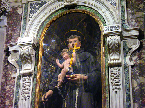 Saint Anthony with baby Jesus and neon cross and halo