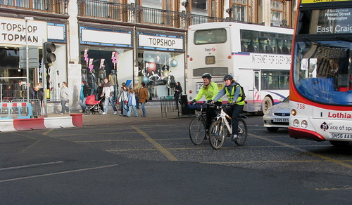 Cyclist with trainer approaching tramlines