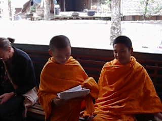 Little Dai monk reads scriptures under duress.