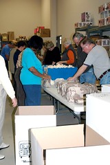 Operation Compassion volunteers load gift bags for an overseas delivery