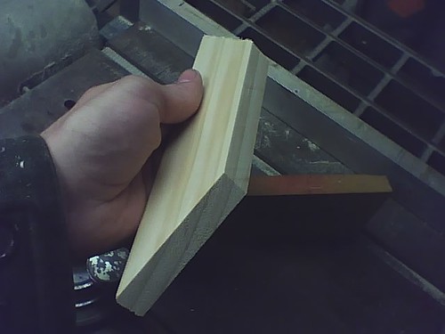 One of the cut pieces. Remember - Trapezoid, not parallelogram. No adjustments need to be made to the guide for this, just flip the wood. Also note my sleeves... not recommended for anyone without a death wish. Loose sleeves, long sleeves, are not the best attire for workshops. 