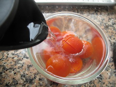 Pour boiling water over tomatoes