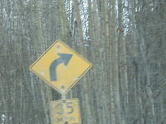 Road sign with bullet holes.