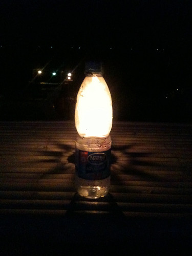 Bottle of water lit at night