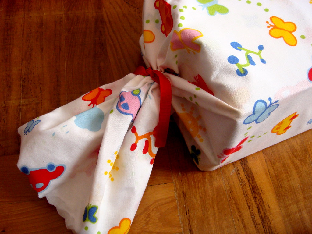 1 yard of Ikea fabric, wave-cut, rubber bands at both ends & finished with ribbons