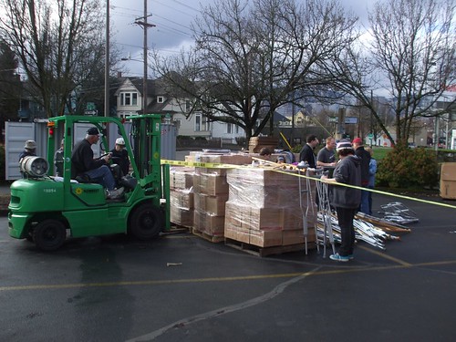 a forklift loading boxes into the container