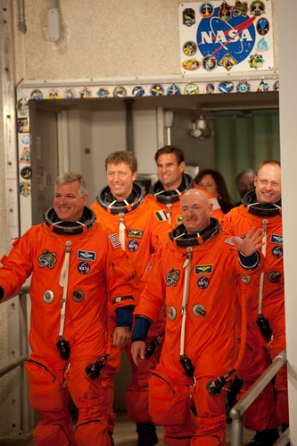 Smiling STS-134 crew walks out