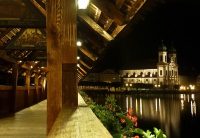 Wooden Bridge and Jesuit church reflected on lake, Lucerne