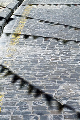 cobbles with shadows of celebration flags