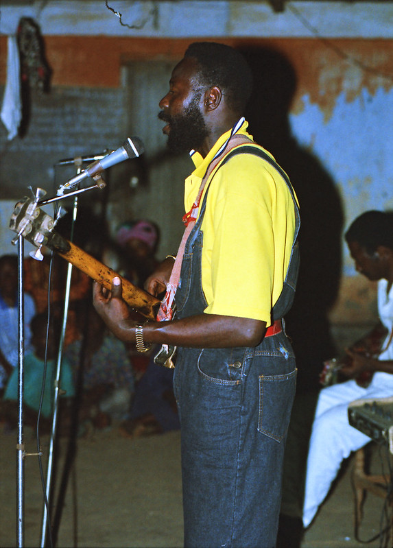 Togo West Africa Local Ethnic Cultural Orchestra Band and Show African Village close to Palimé formerly known as Kpalimé a city in Plateaux Region Togo near the Ghanaian border 23 April 1999 107<br/>© <a href="https://flickr.com/people/41087279@N00" target="_blank" rel="nofollow">41087279@N00</a> (<a href="https://flickr.com/photo.gne?id=13980334264" target="_blank" rel="nofollow">Flickr</a>)