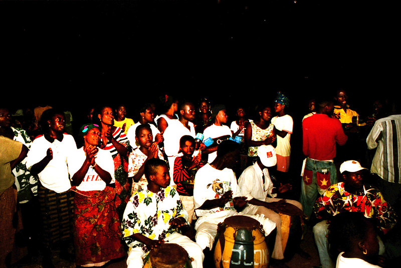 Togo West Africa Ethnic Cultural Dancing and Drumming African Village close to Palimé formerly known as Kpalimé a city in Plateaux Region Togo near the Ghanaian border 24 April 1999 151 Drumming<br/>© <a href="https://flickr.com/people/41087279@N00" target="_blank" rel="nofollow">41087279@N00</a> (<a href="https://flickr.com/photo.gne?id=13987568435" target="_blank" rel="nofollow">Flickr</a>)
