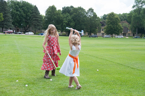 Nora and Charlotte either dancing or playing golf on the parade field.  Can't tell which. • <a style="font-size:0.8em;" href="http://www.flickr.com/photos/96277117@N00/14615750969/" target="_blank">View on Flickr</a>