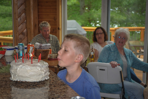 Kai blows out the candles on the cake Grandma made. • <a style="font-size:0.8em;" href="http://www.flickr.com/photos/96277117@N00/14576727474/" target="_blank">View on Flickr</a>