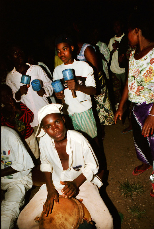 Togo West Africa Ethnic Cultural Dancing and Drumming African Village close to Palimé formerly known as Kpalimé a city in Plateaux Region Togo near the Ghanaian border 24 April 1999 145 Drumming<br/>© <a href="https://flickr.com/people/41087279@N00" target="_blank" rel="nofollow">41087279@N00</a> (<a href="https://flickr.com/photo.gne?id=13988009584" target="_blank" rel="nofollow">Flickr</a>)