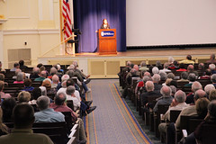 Debby addressing large audience in Dodd Auditorium